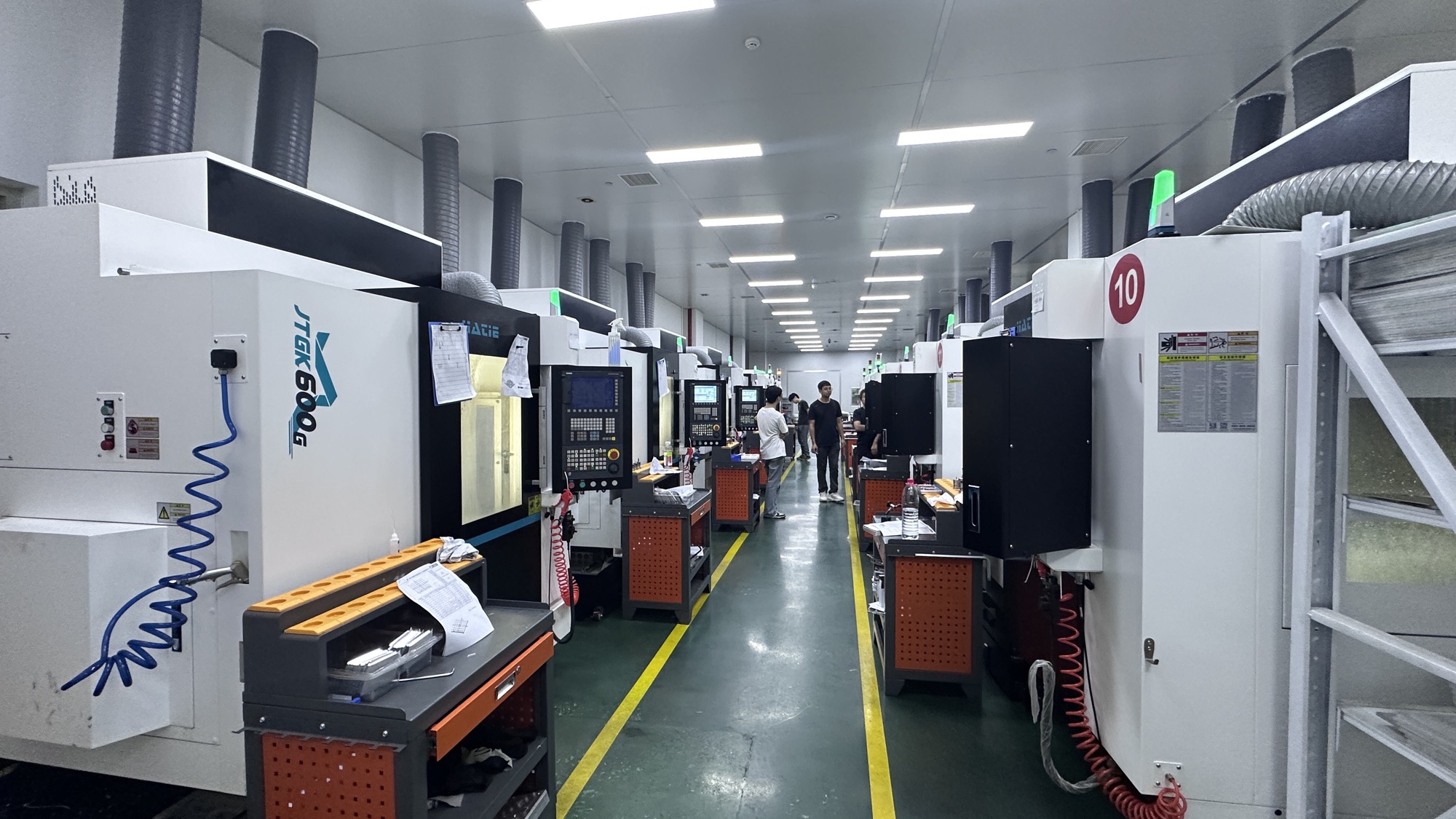 Two organized rows of Hongye CNC machining centers and production workstations